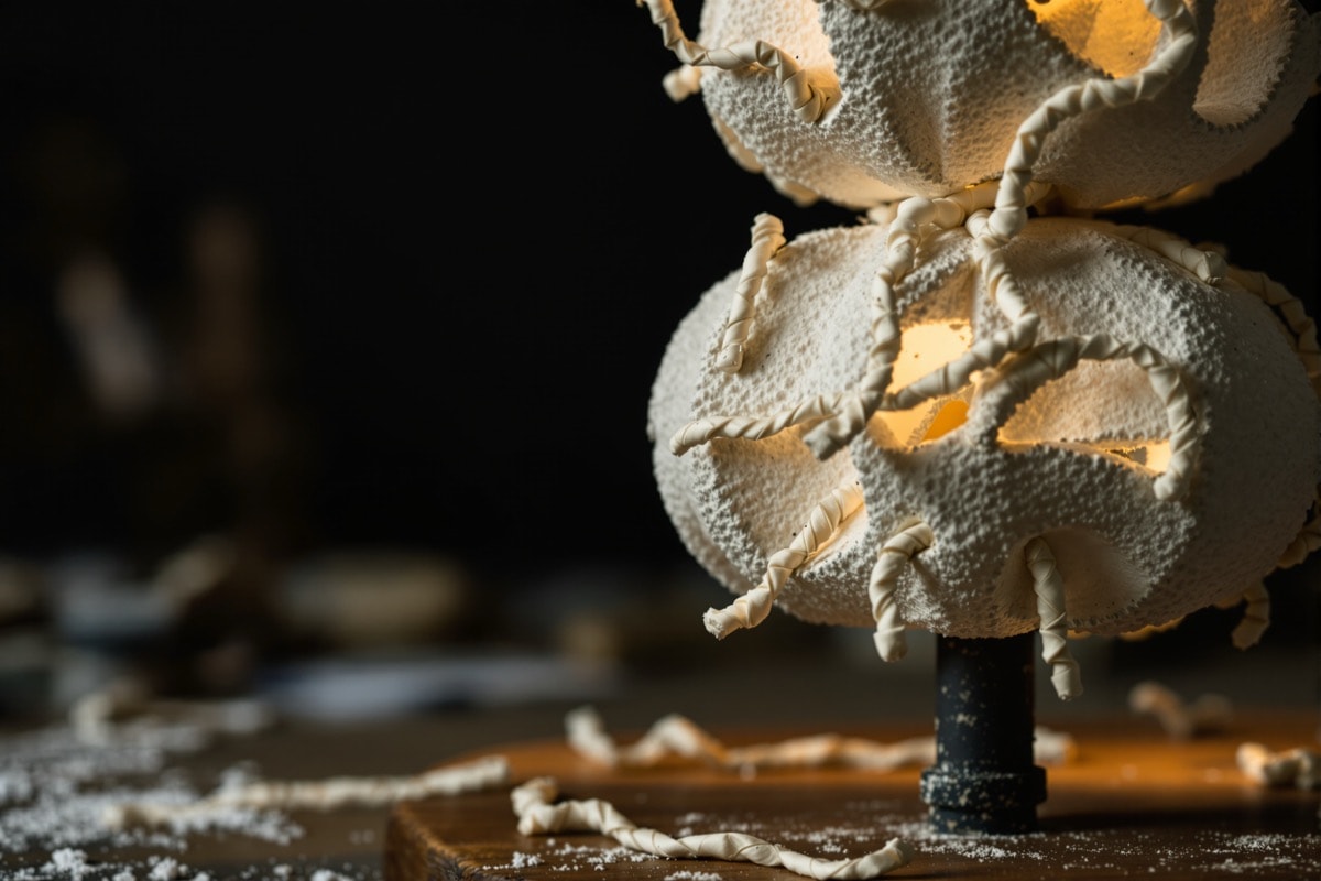 Detail of the stacked skulls with glue-filled gaps and painted paper-towel vines