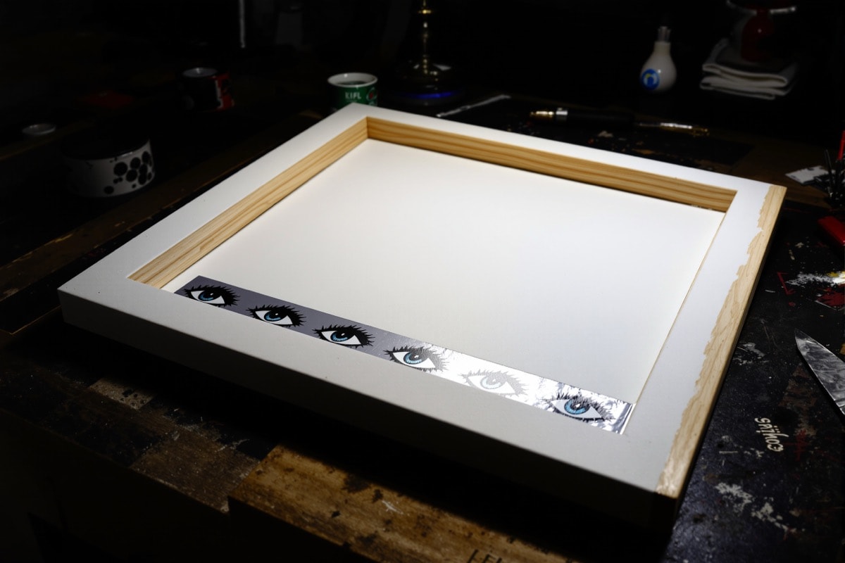 The back of the haunted portrait showing the foamcore recess holding the printed eyes